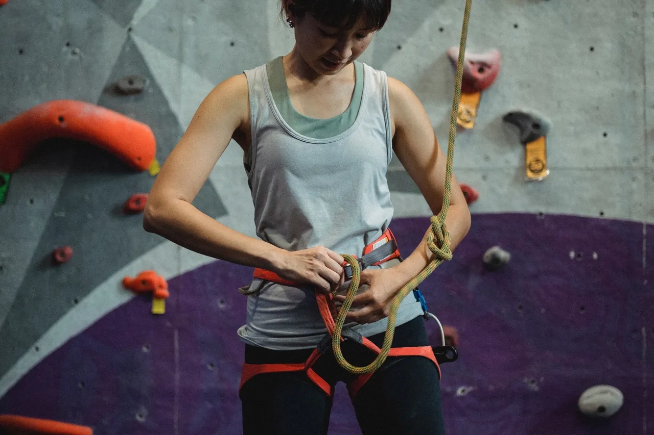 Climber tying belay rope
