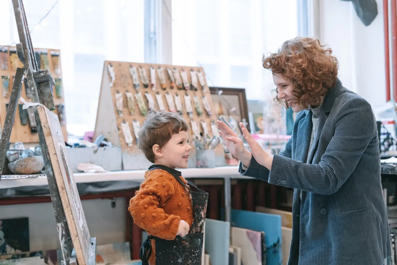 Woman and boy inside art studio